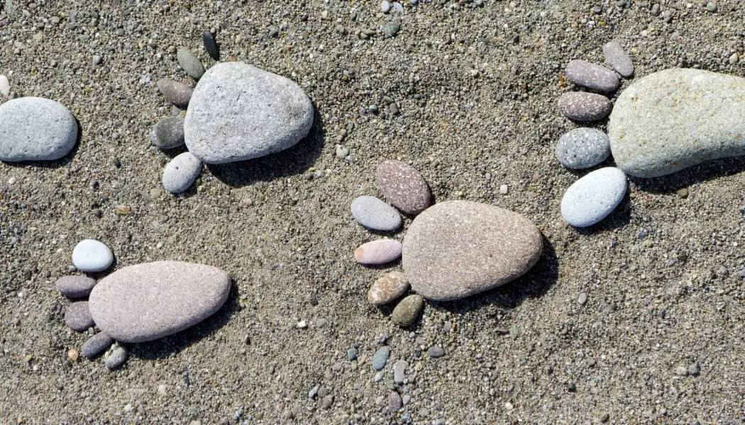Pebble footprints in sand